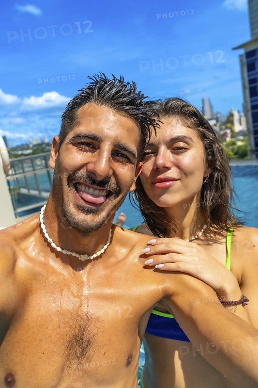 Tourists enjoying summer holidays by the pool, capturing joyful selfies against the vibrant backdrop of cebu city, philippines
