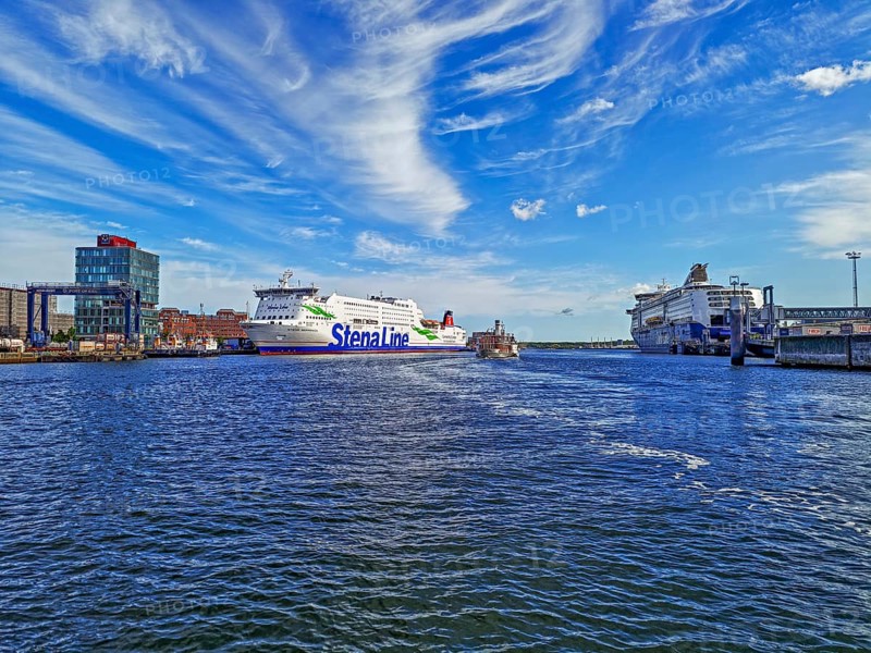 View of the terminals of the Stena Line Sweden ferry and the Color Line Norway ferry, Color Fantasy, harbour facility Port of Kiel, historic paddle steamer Frya, goods train and crane, cirrocumulus clouds, blue sky and sunshine, Kiel, Schleswig-Holstein, Germany
