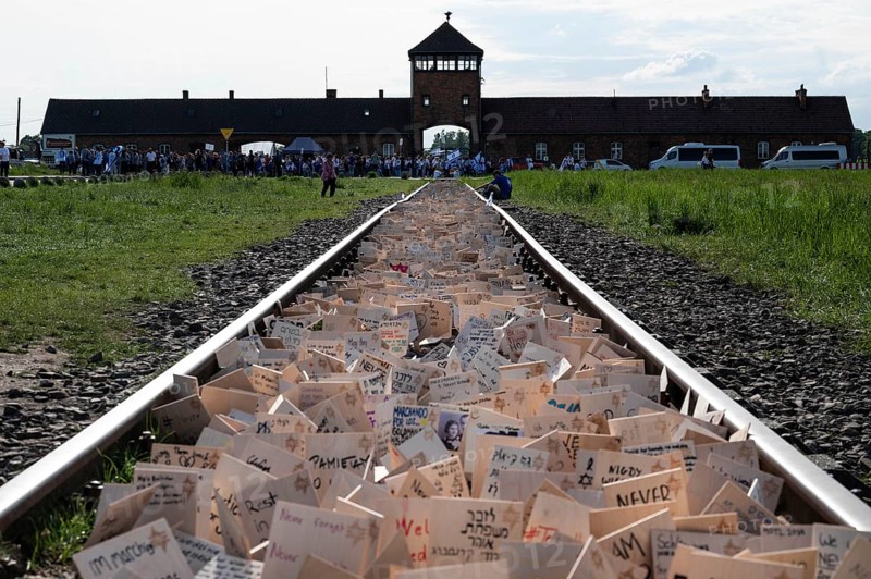 OSWIECIM, POLAND - MAY 6, 2024: March of the Living on the site of the former Auschwitz Birkenau concentration camp. Signs on the tracks left by participants