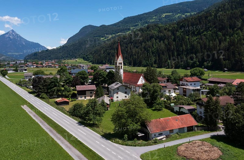 Drone shot, view of village with parish church, Schönwies, Oberinntal, Tyrol, Austria