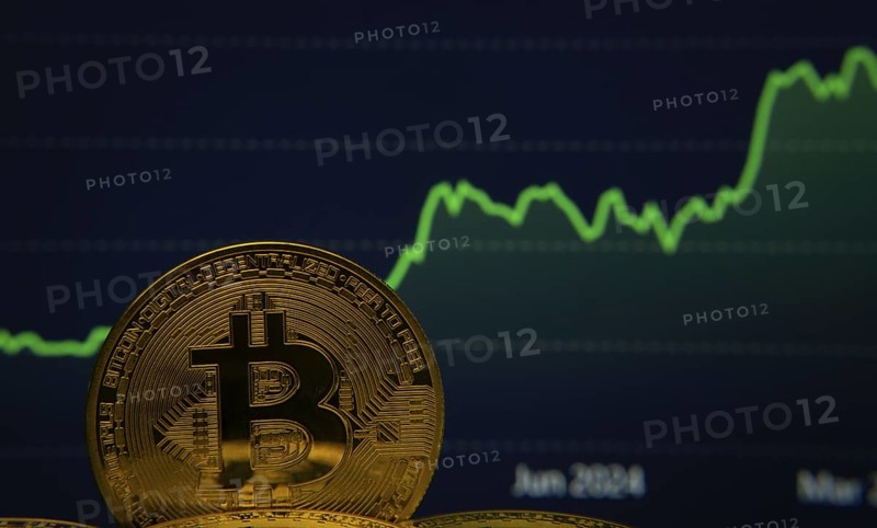 The golden Bitcoin gleams against the backdrop of a surging green line graph, symbolizing the volatile yet potentially lucrative nature of cryptocurrency investments