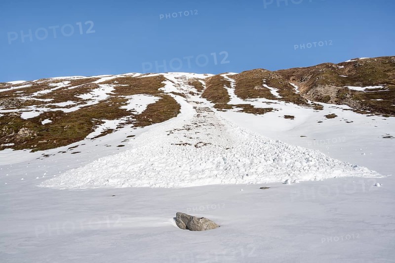 Snow avalanche on a steep grassy slope, spring situation, Graubünden, Switzerland