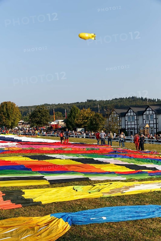 Hot-air balloons, many balloon envelopes lying on the ground, preparation for mass launch, hot-air balloon festival, Warsteiner International Montgolfiade, Warstein, Sauerland, North Rhine-Westphalia, Germany