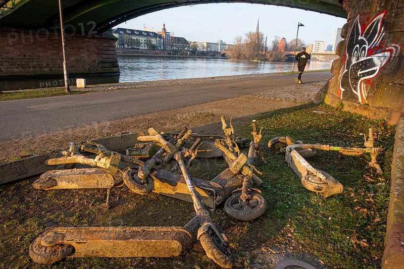 Several electric scooters that were pulled out of the Main in Frankfurt lie as scrap metal on the banks of the Main, Frankfurt am Main, Hesse, Germany