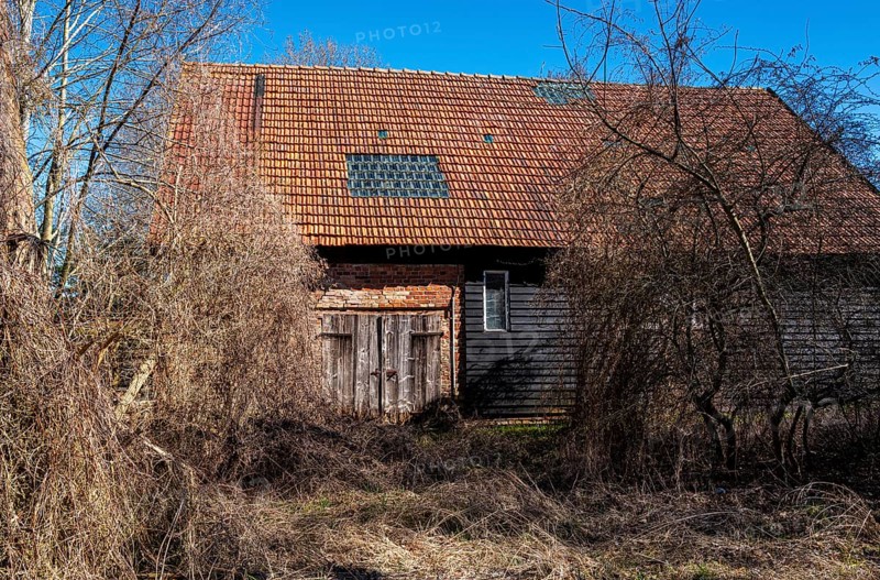 Abandoned and derelict farmhouses on undeveloped land in Rügen, Mecklenburg-Vorpommern, Germany