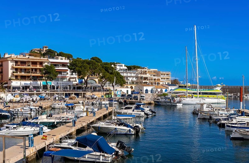 Boats and motor yachts in the small harbour of Cala Rajada, Majorca, Spain