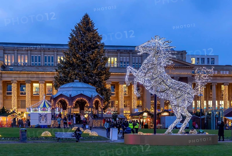 Stuttgart Christmas market at the blue hour. Highlights with sights in front of the Königsbau on Schlossplatz. The traditional event attracts more than three and a half million people to the city centre during the Christmas season. Stuttgart, Baden-Württemberg, Germany