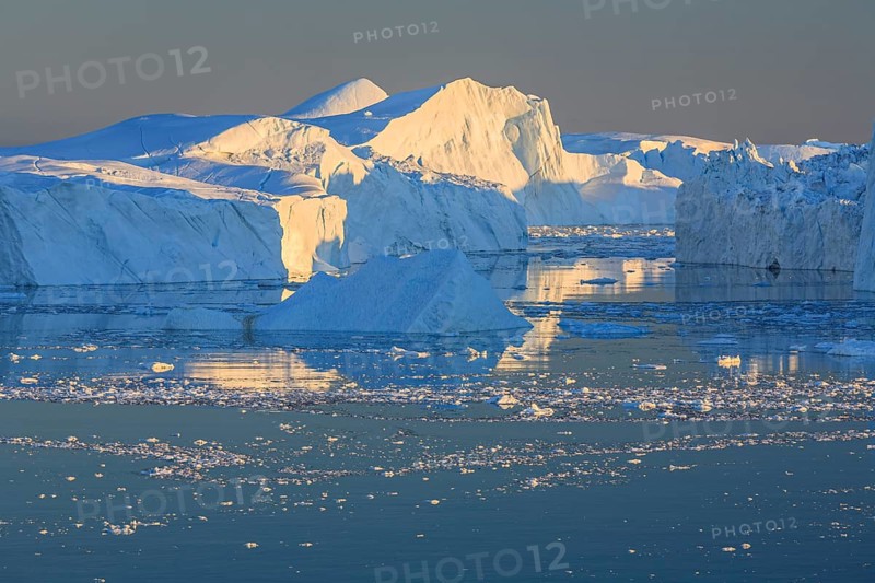 Icebergs and ice floes reflected in the water, summer, midnight sun, Jakobshavn glacier and ice fjord, Ilulissat Kangerlua, Disko Bay, West Greenland, Greenland