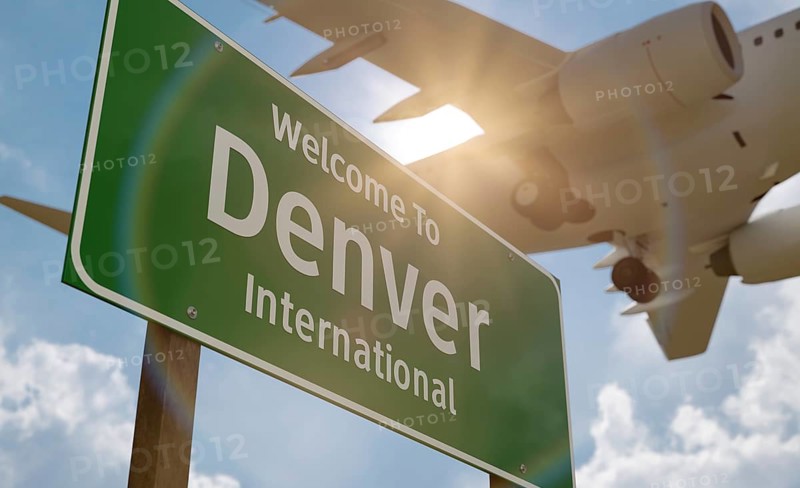 Welcome to denver international airport green road sign with airplane above