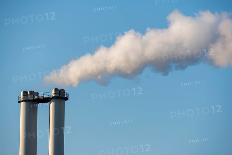 Smoke rises from industrial chimneys into the clear sky, Baden-Württemberg, Germany