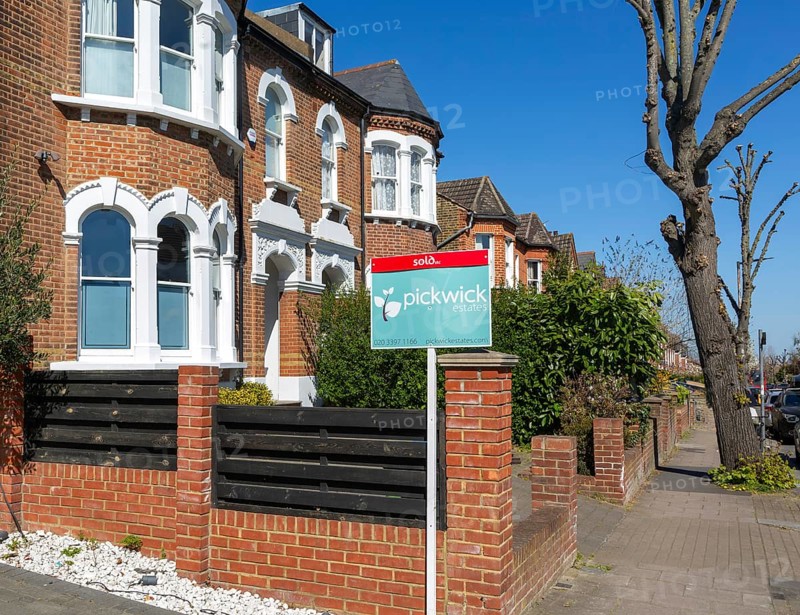 Sold estate agent property sign outside houses for sale, Barry Road, East Dulwich, London SE22, England, UK