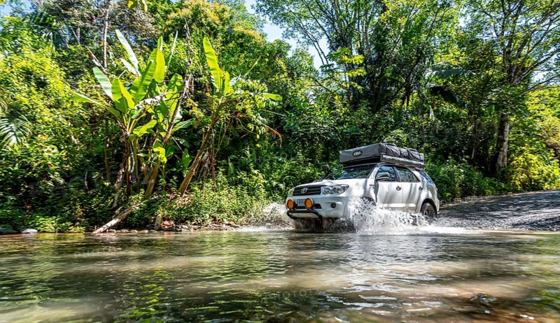 4x4 car drives through a river, water crossing with the off-road car, Costa Rica