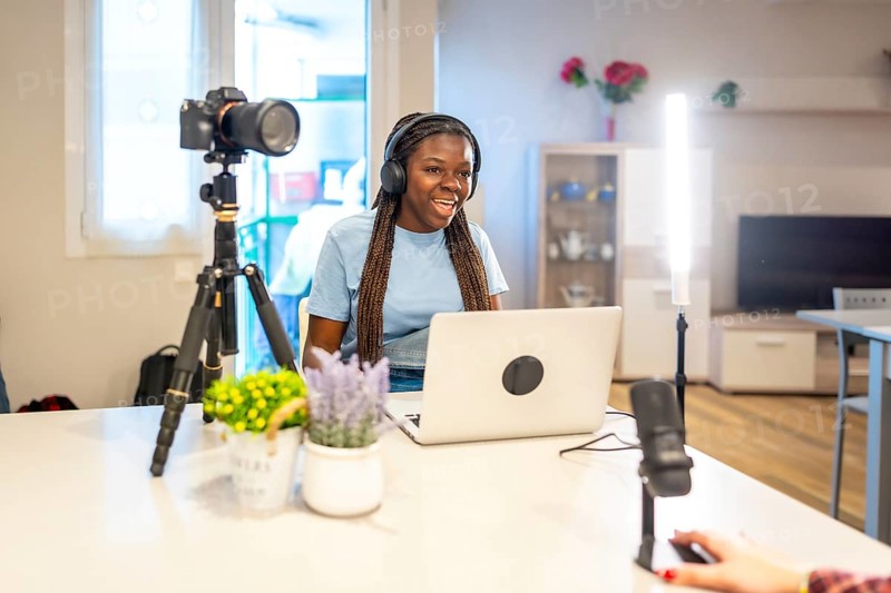 Teenager vlogger creating video content for social media using professional equipment, including a camera, microphone, and lighting