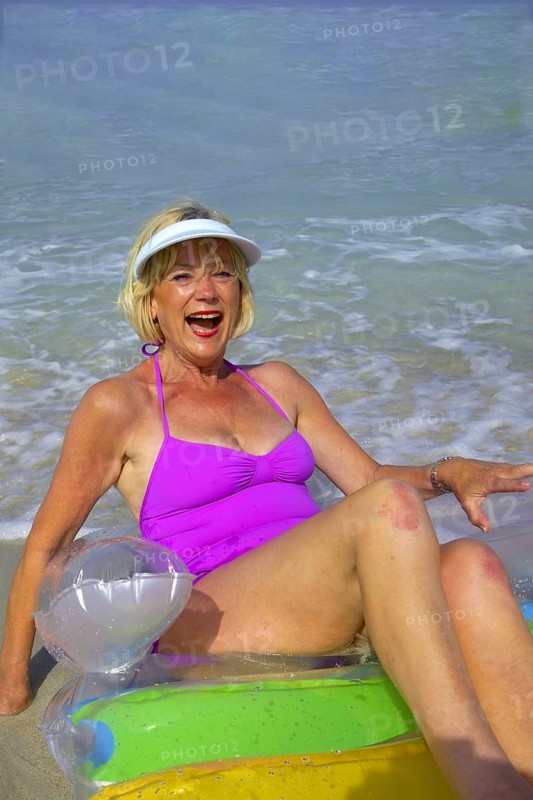 Senior citizen, woman with air mattress on the beach in Ibiza