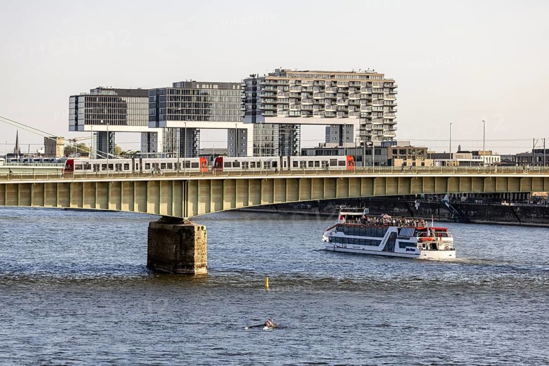 Crane houses on the Rhine Deutz Bridge and excursion boat. City view of Cologne. High-rise buildings in Cologne's Rheinau harbour. Cologne, North Rhine-Westphalia, Germany