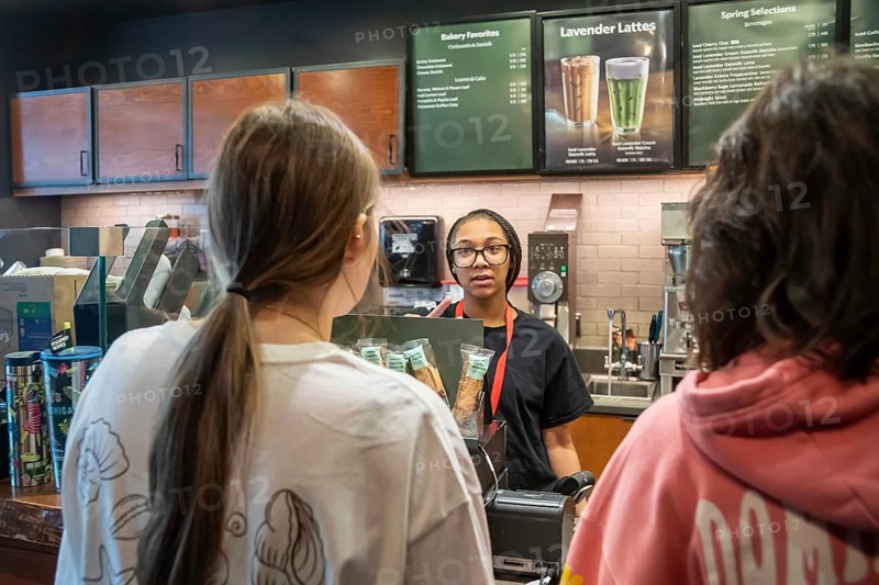 Detroit, Michigan - A young worker takes orders at a Starbucks coffee shop at Detroit Metro Airport