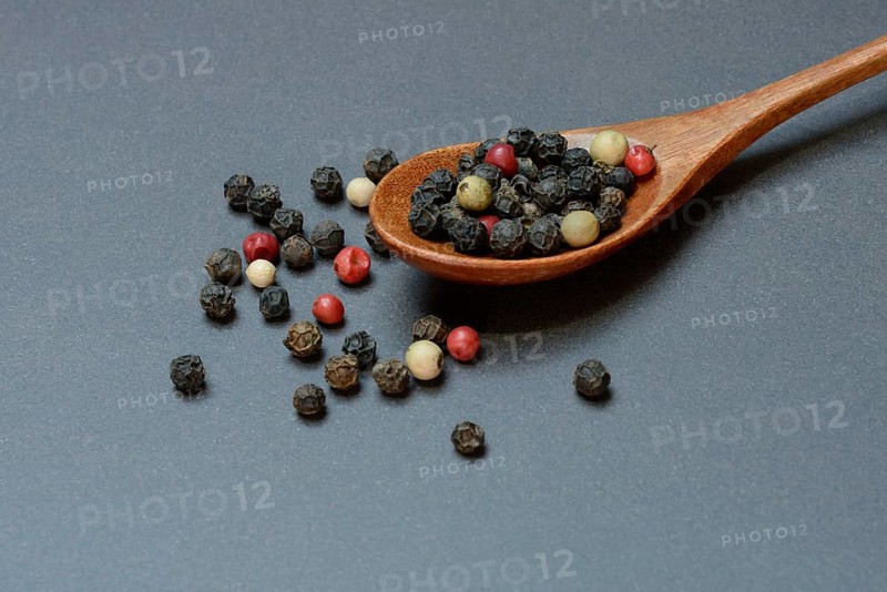 Pepper, various peppercorns in a wooden spoon