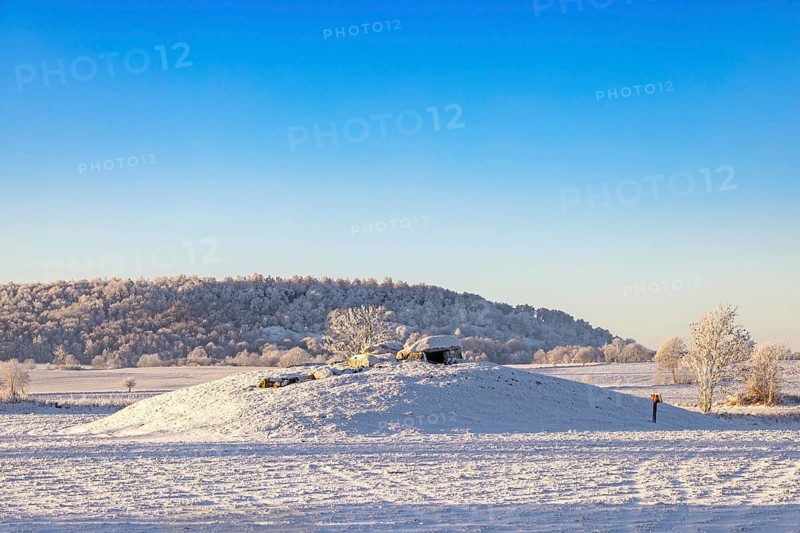 Megalith grave from Stone Age on a hill in a rural landscape with snow and frost on a cold winter day Falköping, Karleby, Sweden
