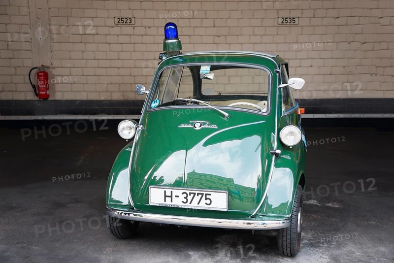 Green vintage tricycle with blue light in garage in front of brick wall, BMW Isetta 300, scooter mobile, police vehicle, Peine, Lower Saxony, Germany