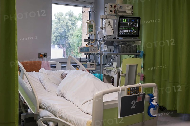 LUBIN, POLAND - JUNE 16, 2025: a patient in a hospital bed and the equipment next to it in the cardiac intensive care unithospital