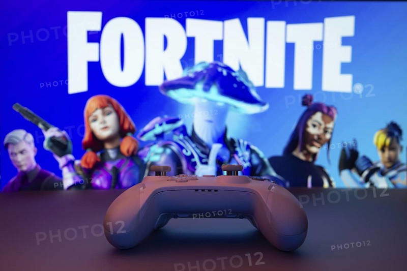 Dhaka, Bangladesh- 12 June 2025: Gaming controller in front of a Fortnite screen with colorful dynamic backgrounds