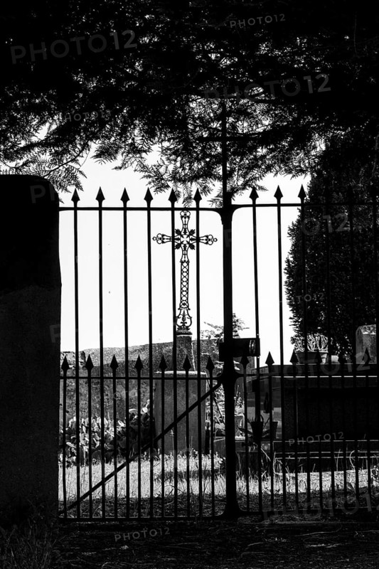 Cross in a cemetery. Esteil village. Livradois-Forez Regional Nature Park. Puy de Dome department. Auvergne-Rhone-Alpes. France