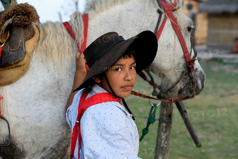Young Gaucho with his horse at Puesto Mingo, portrait, Esteros del Iberá, at Concepción del Yaguareté Corá, Corrientes Province, Argentina