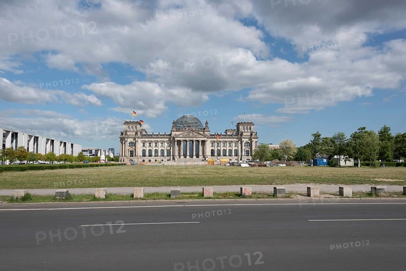 The Reichstag in Berlin under a cloudy sky, seen from a street, Berlin, Germany