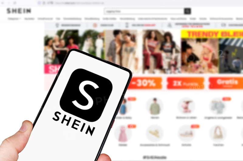 Shein logo online marketplace online trading ecommerce on a mobile phone and computer in Stuttgart, Germany