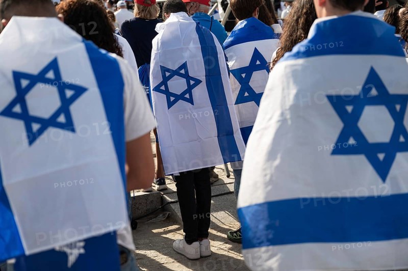Jews with Israeli flags during a ceremony at the concentration camp