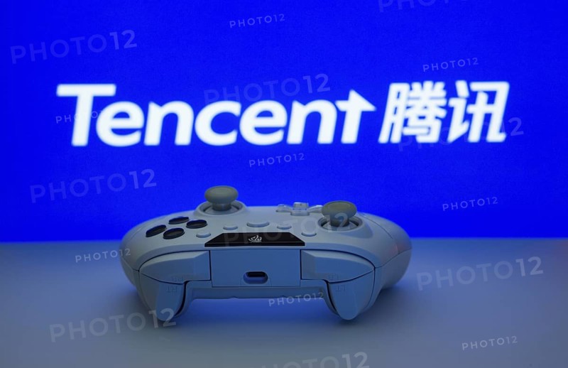 Dhaka, Bangladesh- 12 June 2025: Game controller in front of Tencent logo on a blue background