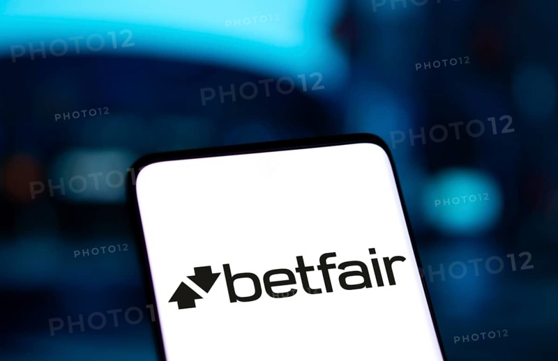 betfair logo is displayed on smartphone. Betfair is a British gambling company