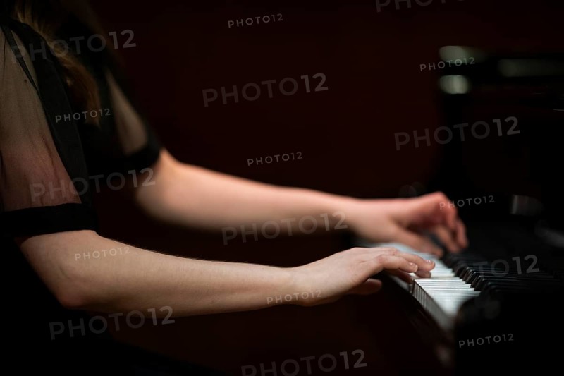 Hands and arms of a young pianist playing on the keyboard of a Steinway & Sons grand piano, Stuttgart, Baden-Württemberg