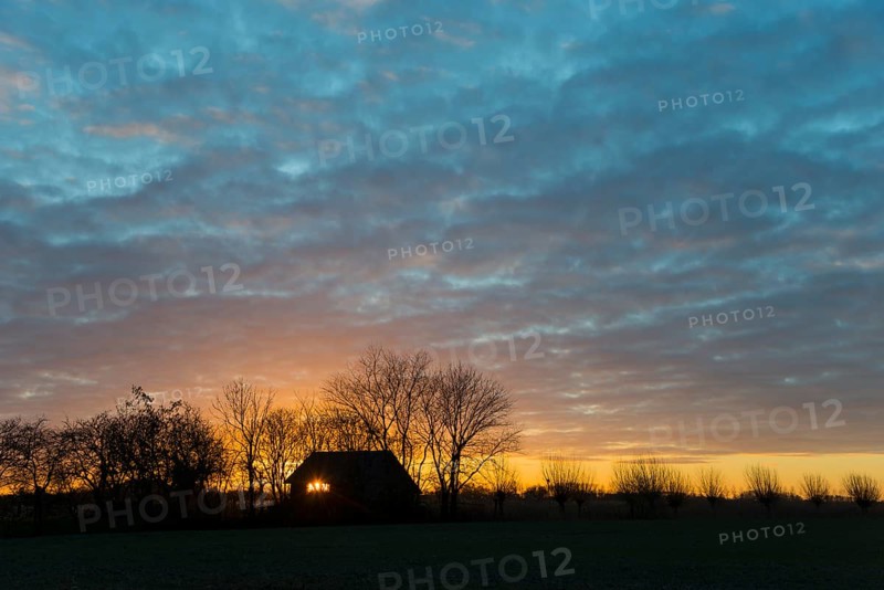 Sunset, sky burning, evening sun shining through a window of a house, house on the Dijkweg, Holwierde, Eemsdelta, Groningen, Netherlands