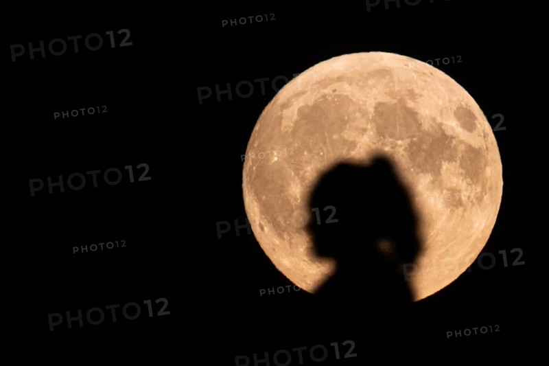The silhouette of a woman stands out against the rising full moon. A supermoon will shine from the sky on 17 and 18 September 2024. On the night of 17 to 18 September 2024, the full moon will be just 357, 500 kilometres away from Earth, Frankfurt, Hesse, Germany
