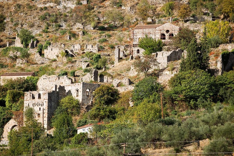 Byzantine ruined city of Mystras or Mistra on the Taygetos Mountains, UNESCO World Heritage Site, in front of olive groves, Laconia, Peloponnese, Greece