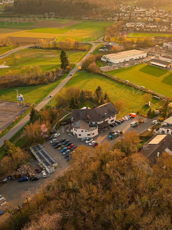 Urban and rural mixed landscape at sunset with forest and sports field, Europäischer Hof, Königsbach, Germany