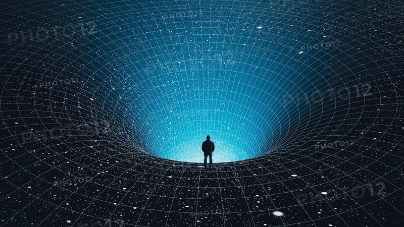 A man stands at the edge of a black hole, gazing into the depths of the universe, surrounded by stars in a mesmerizing cosmic abyss