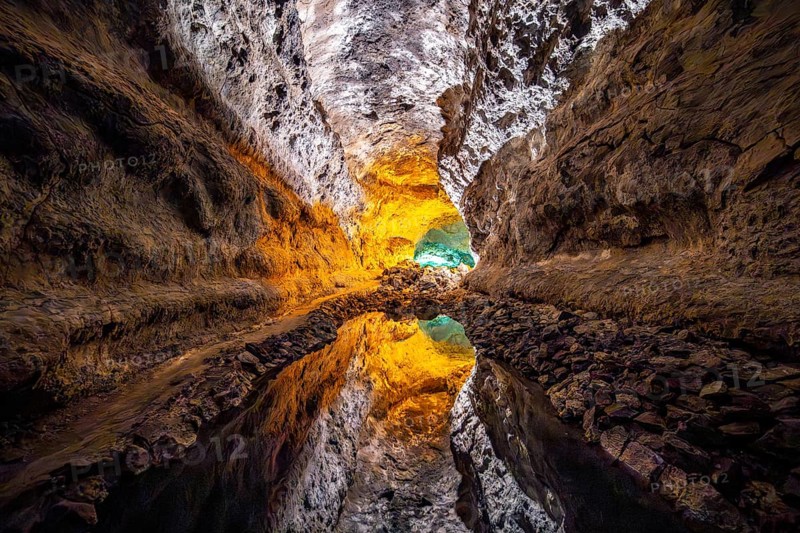 Lava tunnel, illuminated lava cave with perfect reflection in an underground lake, Cueva de los Verdes, Lanzarote, Canary Islands, Spain