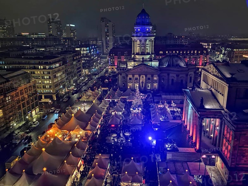 Colourful lighting over festive Christmas market tents on the Gendarmenmarkt