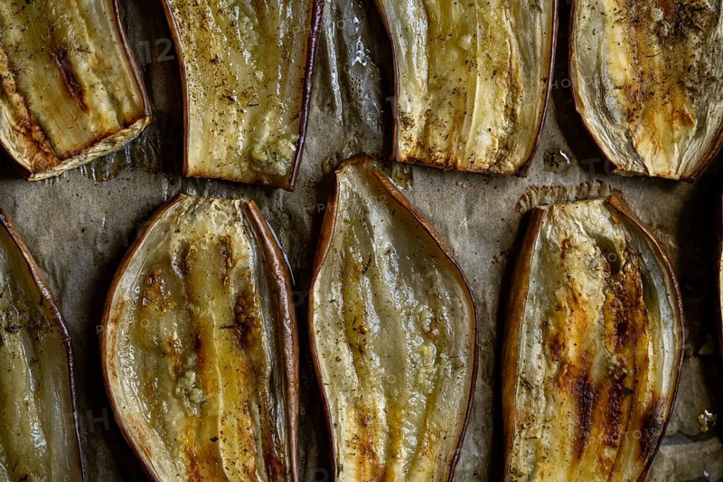 Close-up of oven-roasted eggplant slices, perfectly baked for a healthy vegetarian meal. The rich texture and rustic look highlight Mediterranean cuisine's essence