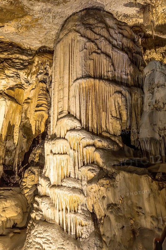 Majestic stalagmite formation rising from the cave floor, showcasing nature's artistry in postojna cave, a popular tourist attraction in slovenia