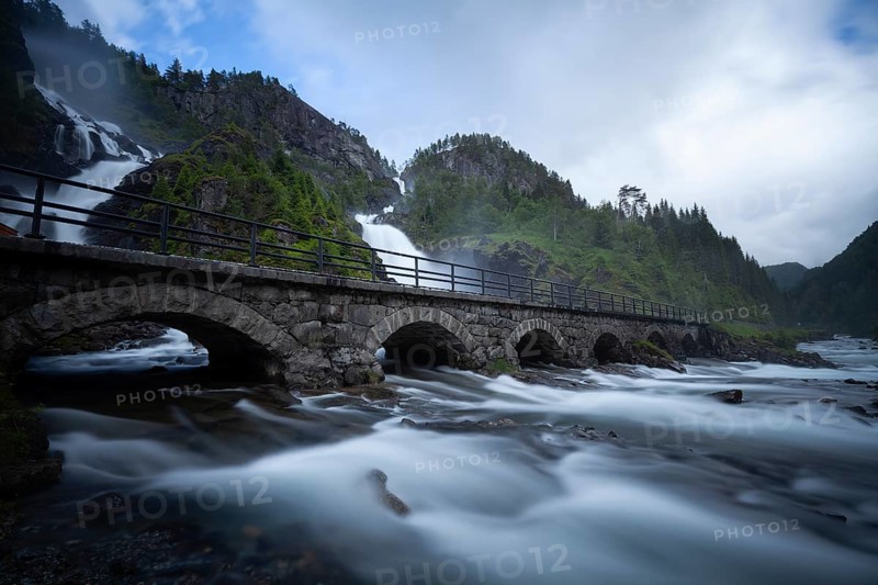 Summer day visiting Låtefossen falls near Odda, flowing water and green valley, Vestland, Norway