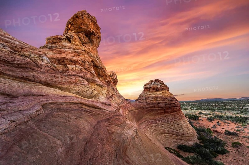 Capture the breathtaking sunset over the unique sandstone formations of Coyote Buttes in the Paria Canyon-Vermilion Cliffs Wilderness, Arizona, USA, showcasing vibrant skies and intricate rock patterns