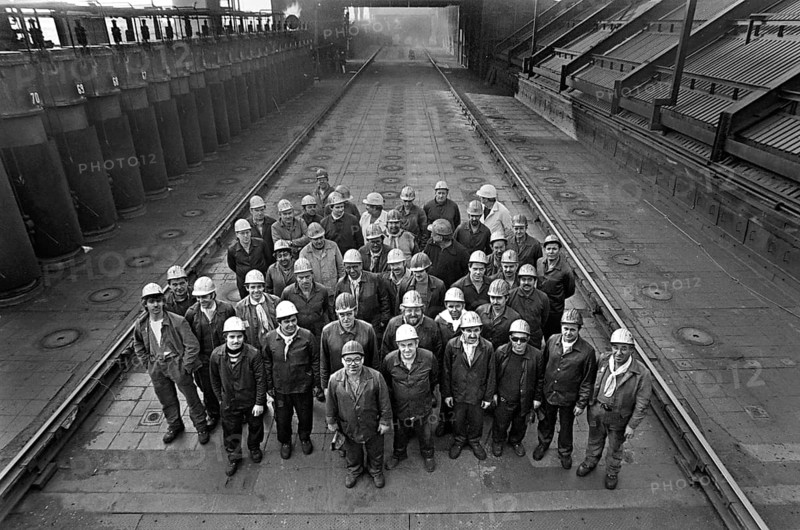 Essen, DEU, 17.11.85 - Workers at the Zollverein coking plant, shift group on the oven ceiling. The coking plant was discontinued in 1993. Together with Zollverein Colliery, the former coking plant was declared a World Heritage Site by UNESCO in 2001, Essen, Germany