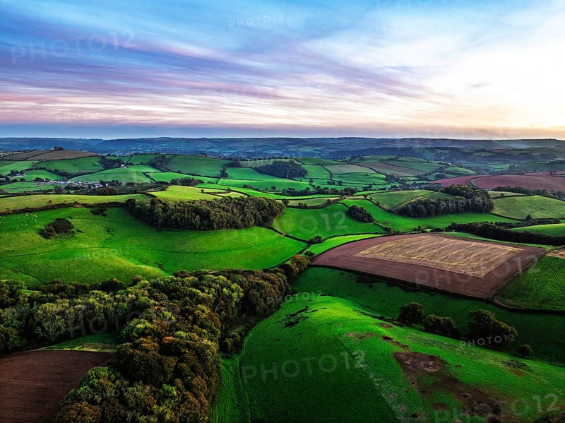 Sunset of Devon Farms and Fields over Berry Pomeroy from a drone, Totnes, England, United Kingdom