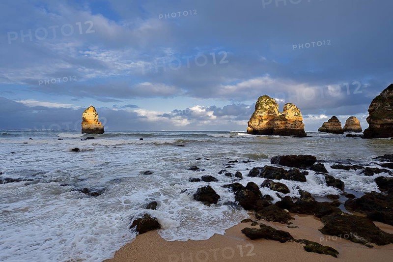 Rock formations on the coast in the evening light, Praia do Camilo, Lagos, Algarve, Portugal