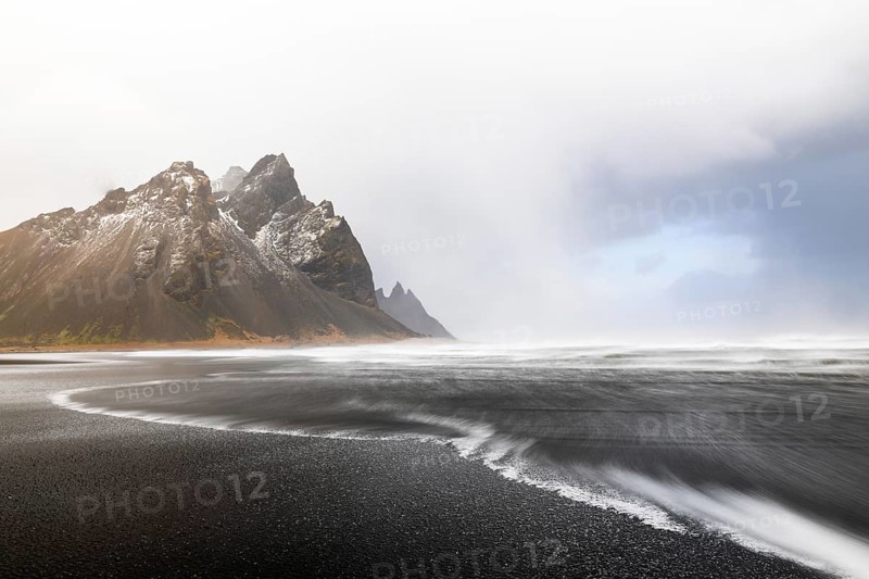 Sea waves on lava sandy beach against mountain backdrop, sea, snow, winter, Stokksnes, Vestrahorn, Klifatindur, Höfn, Iceland, Scandinavia