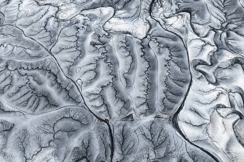 Stunning aerial photograph captures the intricate patterns of Moonscape Overlook in Utah, showcasing its unique and rugged terrain