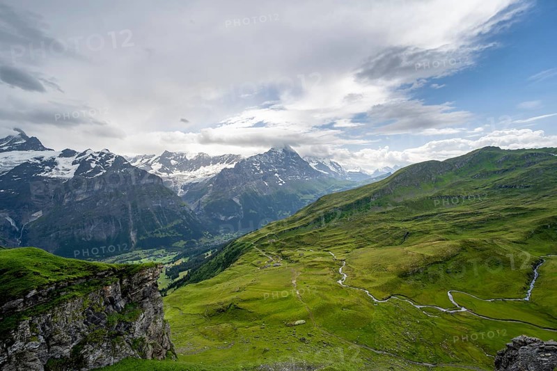 View of the mountain landscape of Grindelwald First, snow-capped mountain peaks Eiger and Schreckhorn, Grindelwald, Bernese Alps, Bernese Oberland, Switzerland